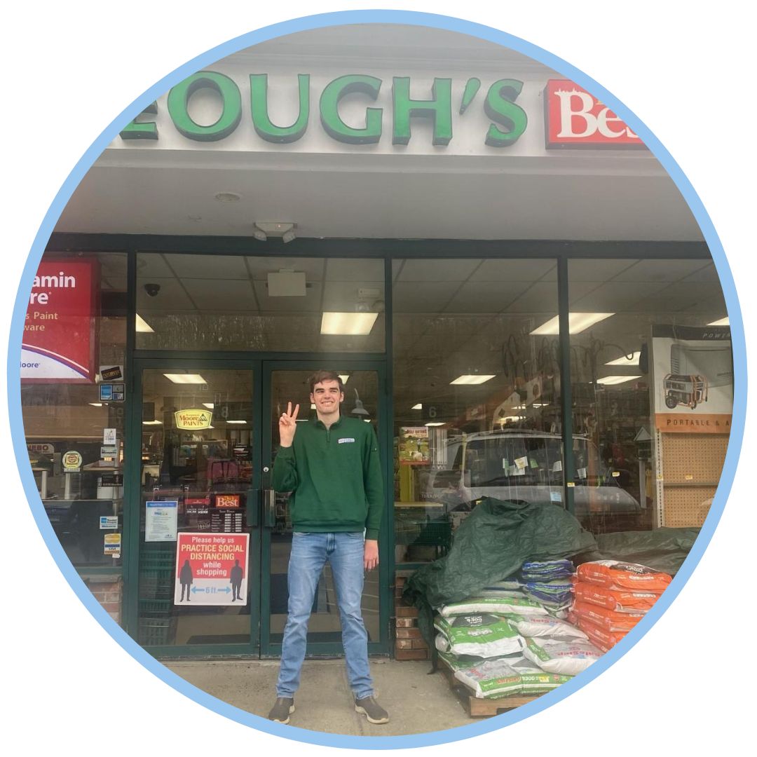 Spencer standing in front of Keough's Harware store.